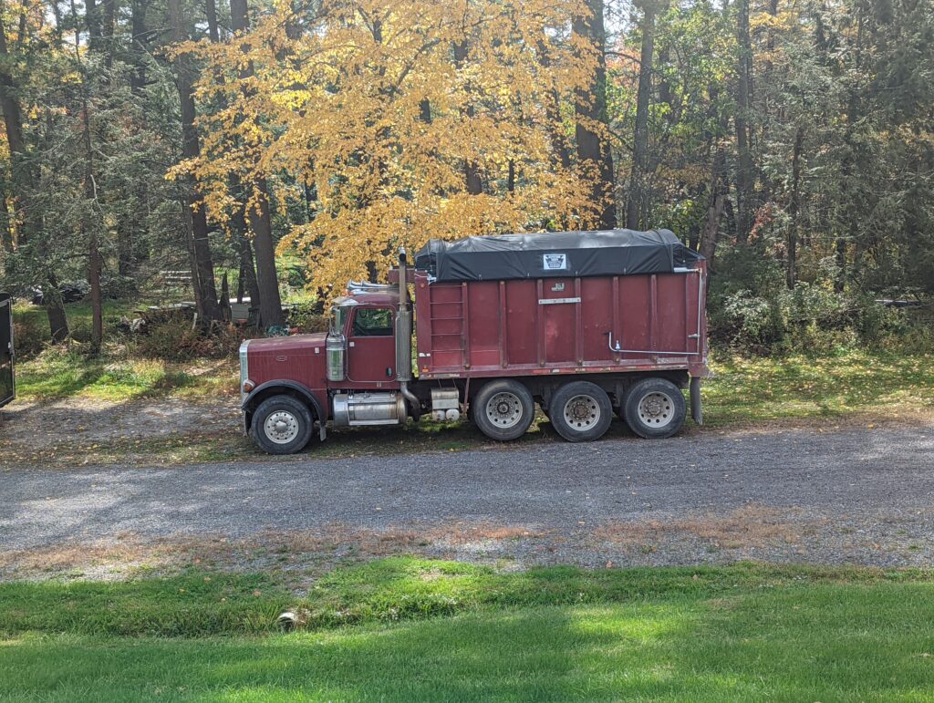 Red Dump Truck with Keystone Tarps roll tarp system.